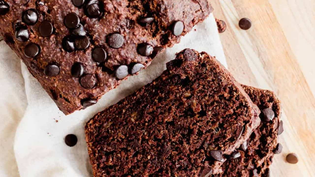Double chocolate banana bread with chocolate chips sliced on a cutting board.