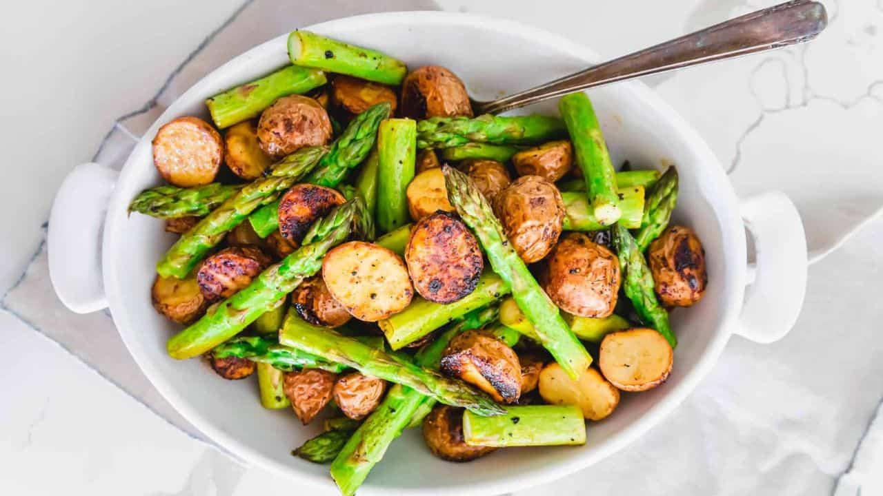 Garlic Balsamic Roasted Asparagus and Potatoes in a white baking dish.