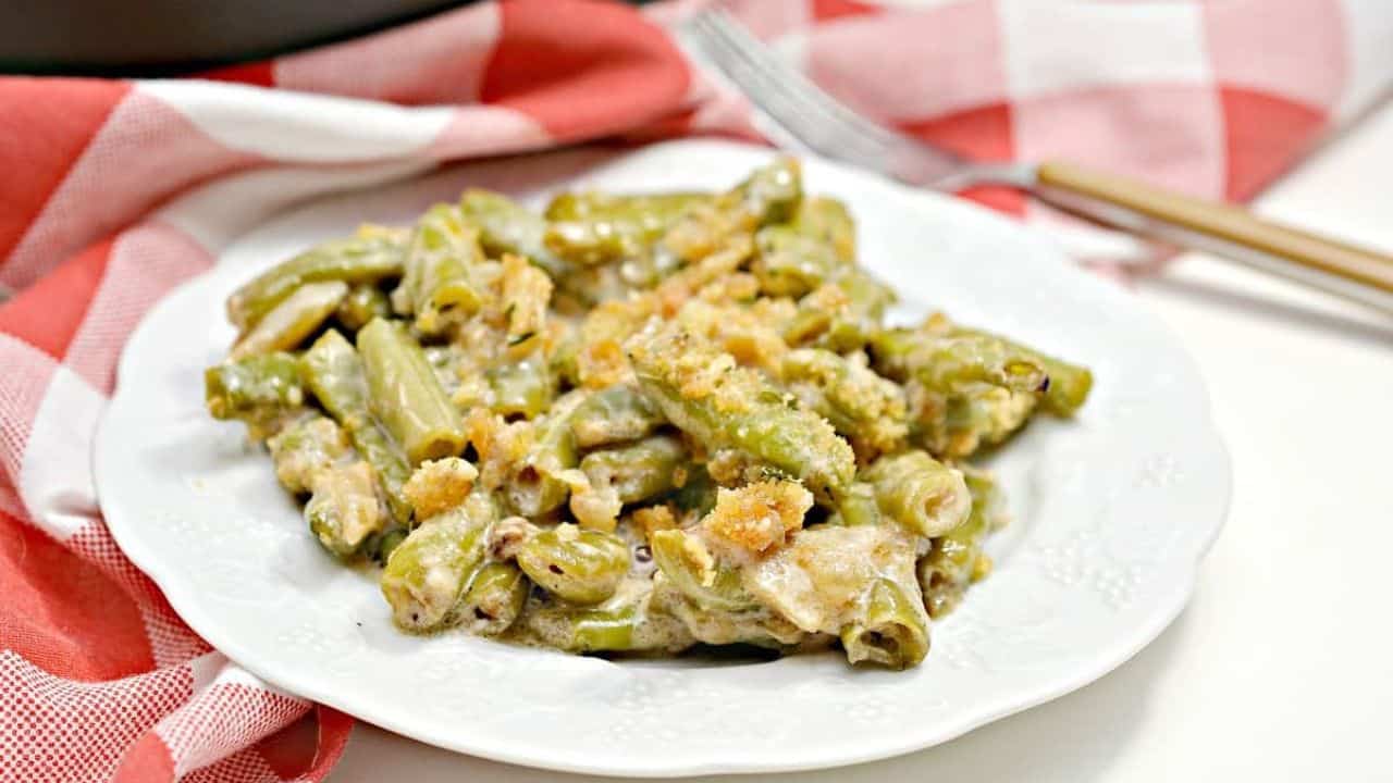 A white plate with green beans on it.