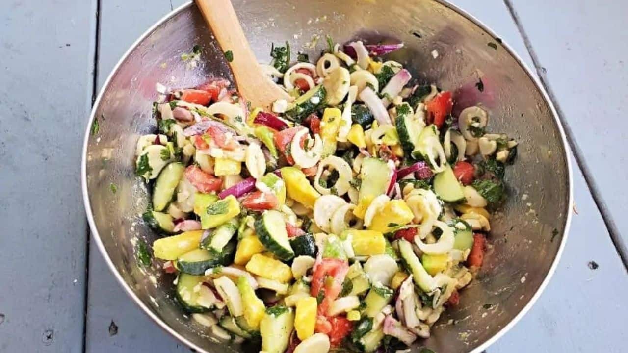 Silver bowl with a veggie filled hearts of palm salad.