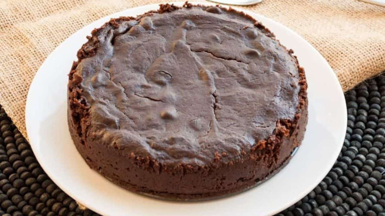 A round of brownies with a wedge cut out of it.