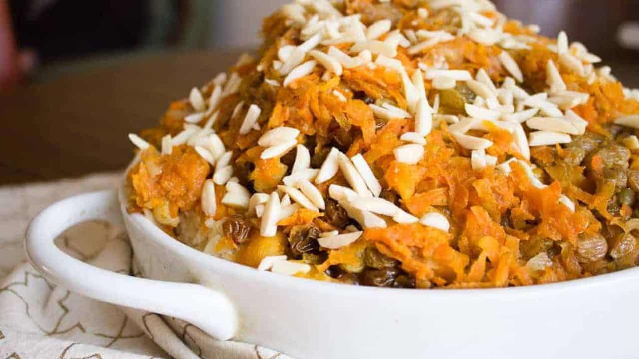 Jeweled vegetarian rice plov topped with shredded carrots, golden raisins, lentils and slivered almonds.