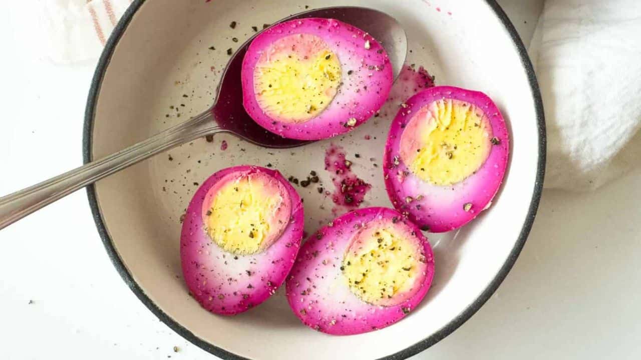 Pink pickled eggs in half.