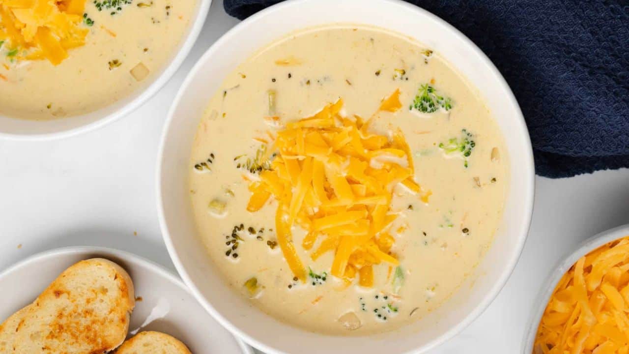 An overview of a bowl of broccoli cheese soup.