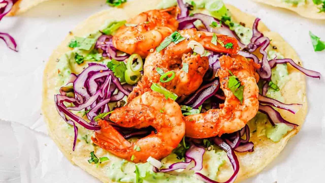Spicy shrimp tostadas on a cutting board.