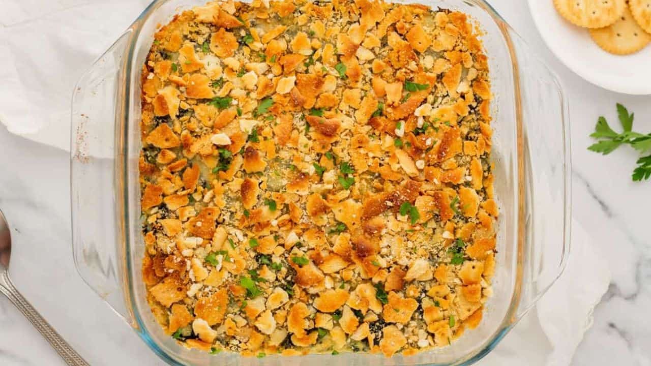 An overview of a plate of spinach casserole with a fork.
