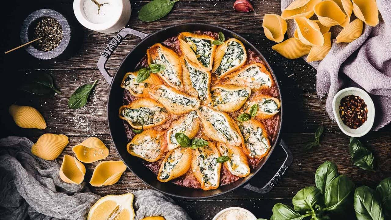 Stuffed shells in a cast iron skillet.