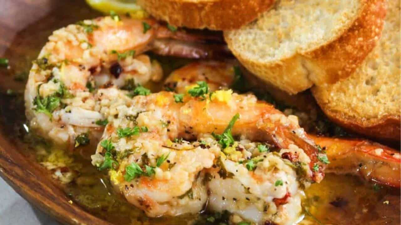 A plate with shrimp and bread on it.
