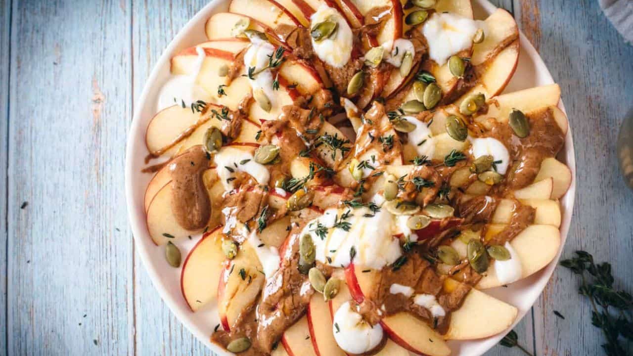 Middle Eastern apple appetizers with cooked chicken and fresh apple chunks skewered on small wooden forks.