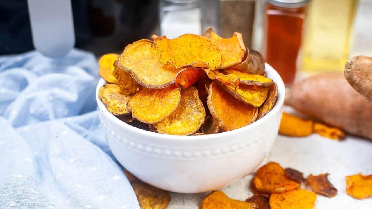 White bowl filled with sweet potato chips.