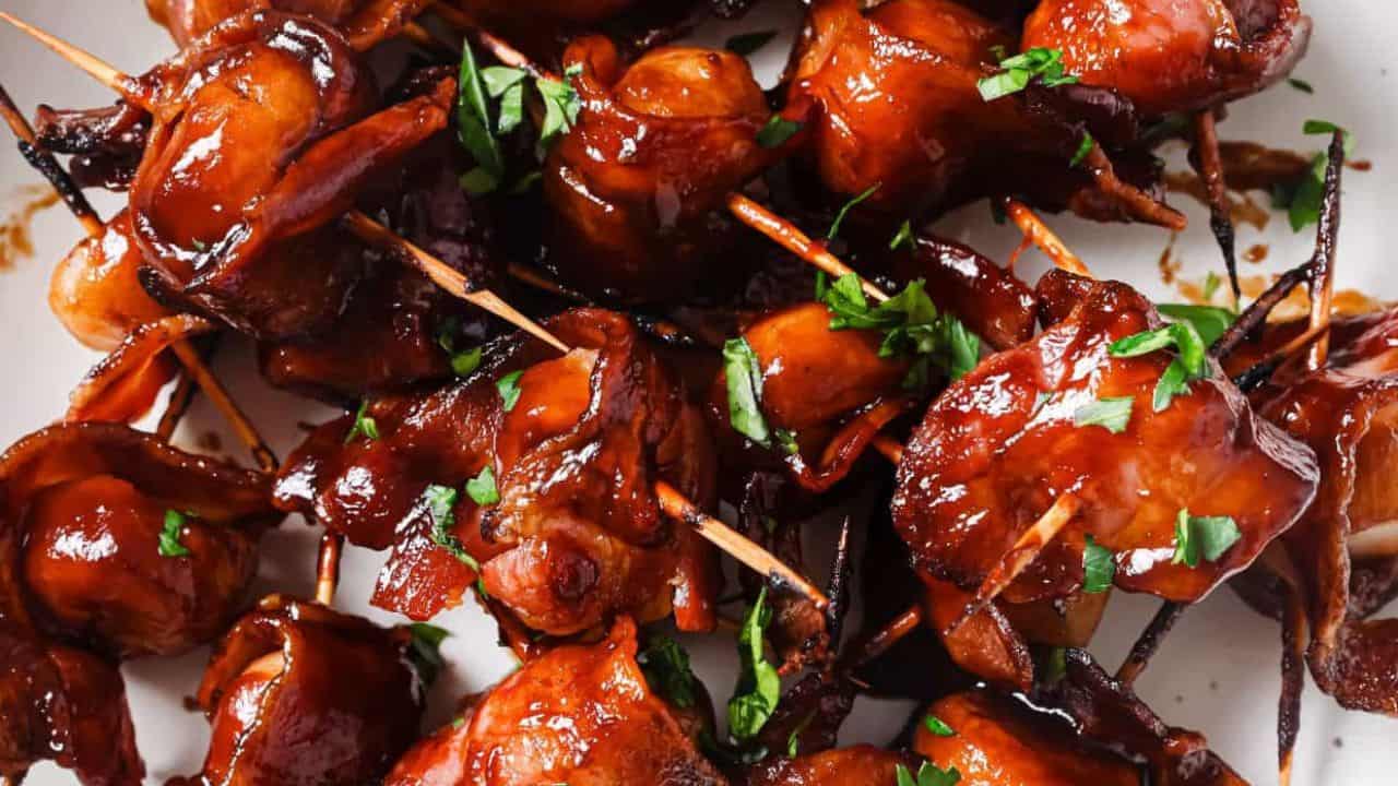 Bacon-wrapped water chestnuts on a plate.
