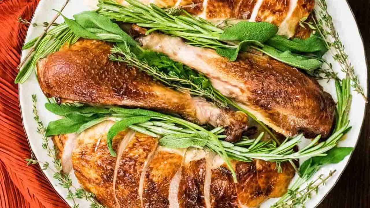 A buttermilk brined roasted surrounded by festive holiday side dishes.