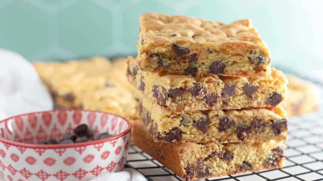 A stack of chocolate chip bars on a cooling sheet.