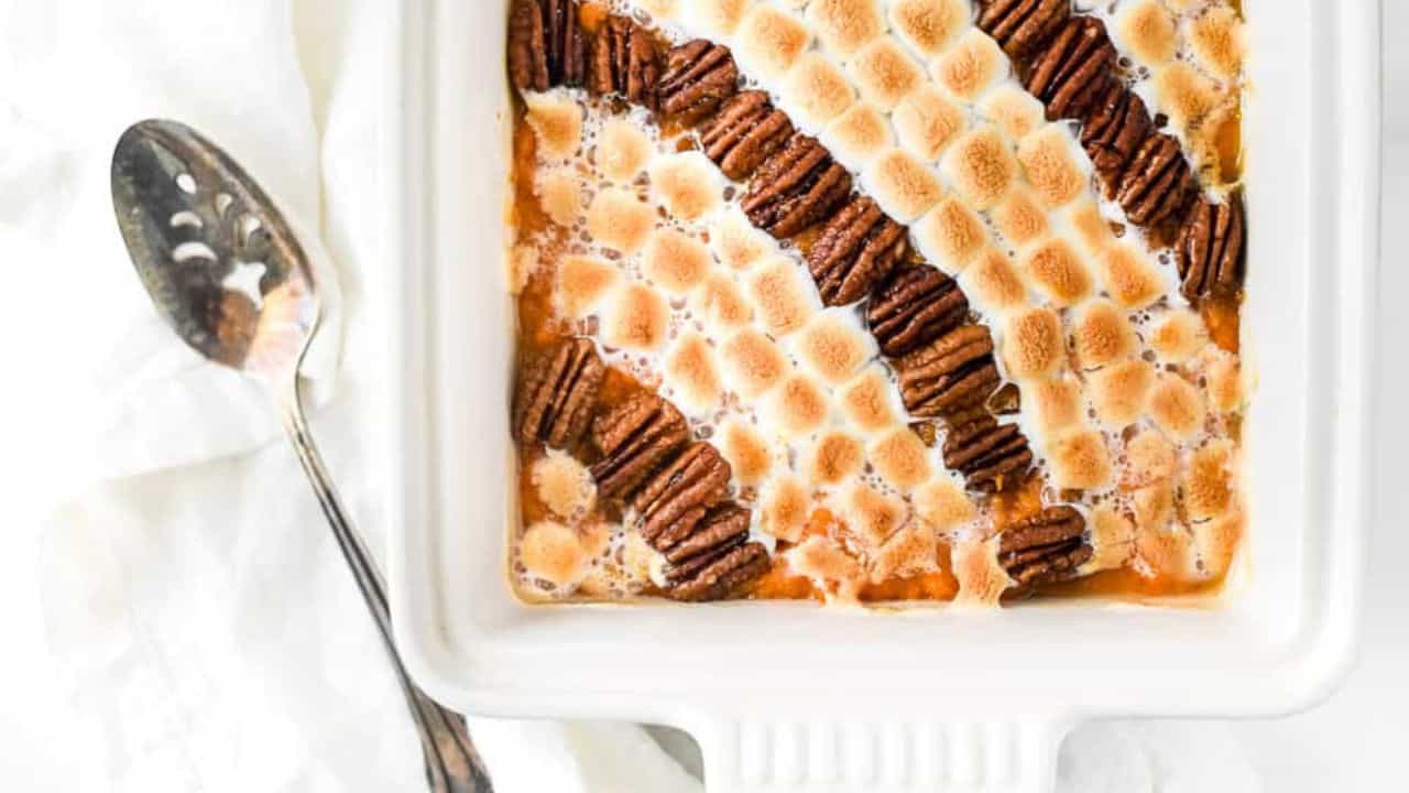 A sweet potato casserole with a scoop out of it.