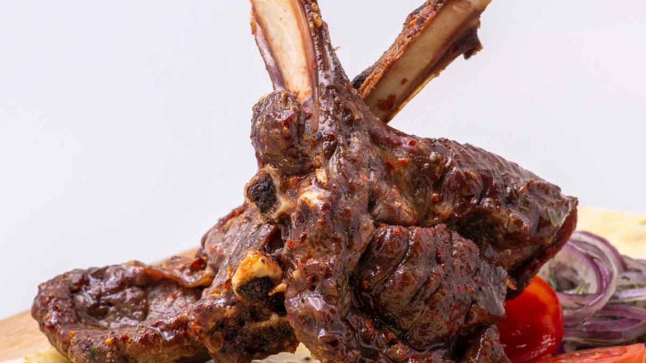 Meat cut into slices on a white plate.