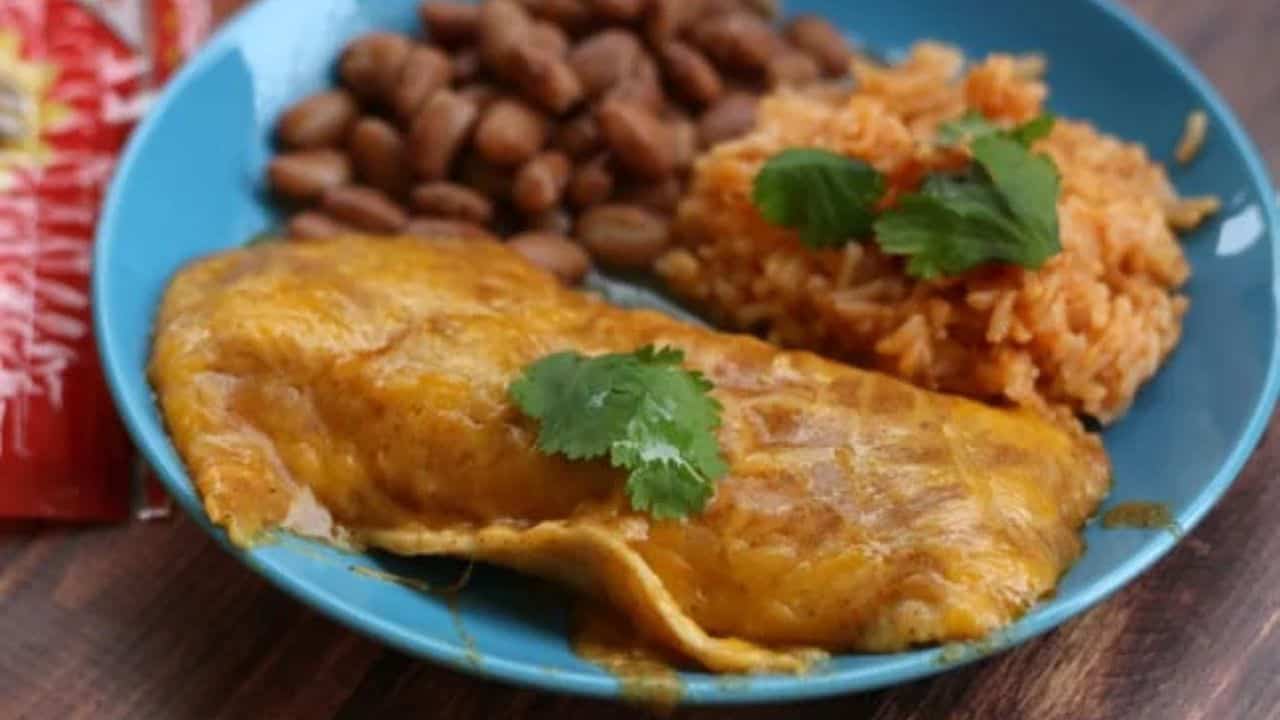 One cheese enchilada and rice and beans on a plate.