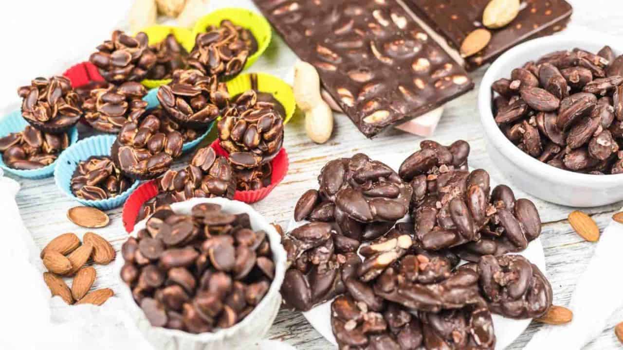 An assortment of chocolate-covered nuts and chocolate bars.