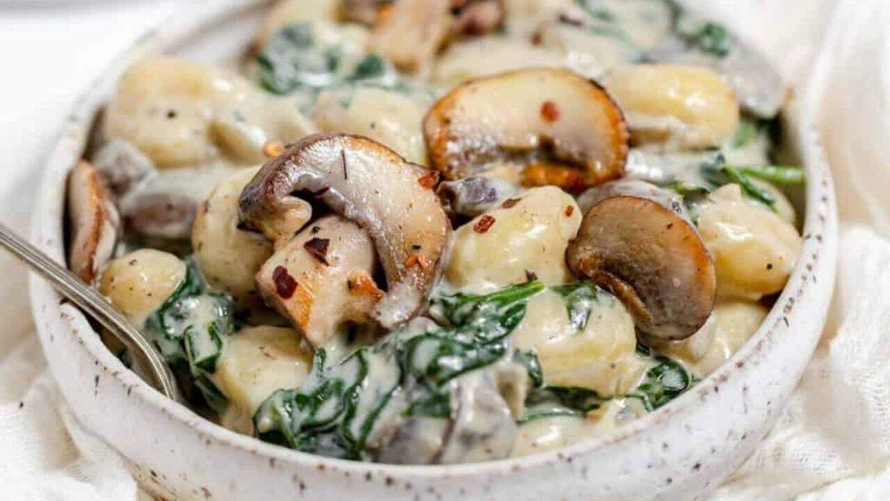 A pan of creamy mushrooms and gnocchi.