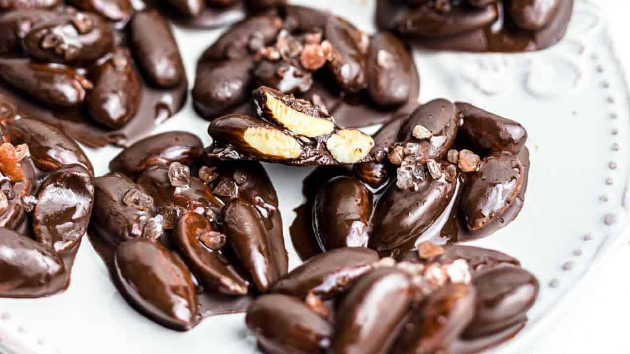 A wicker basket filled with chocolate covered nuts.