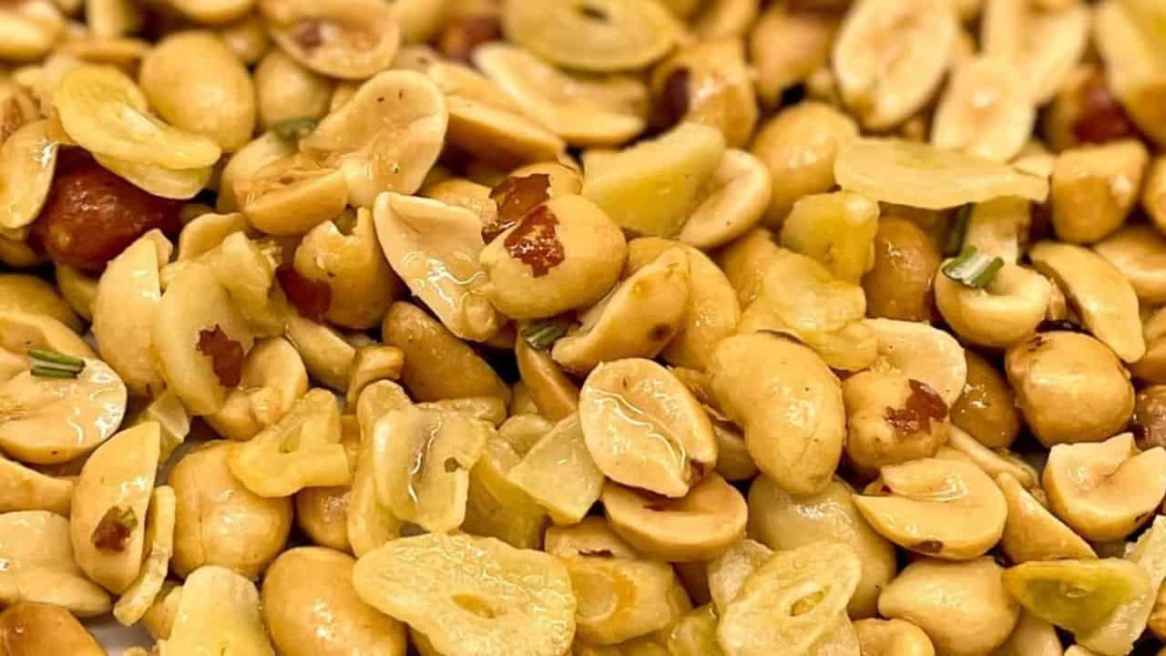 Close-up shot of garlic peanuts with chopped rosemary.