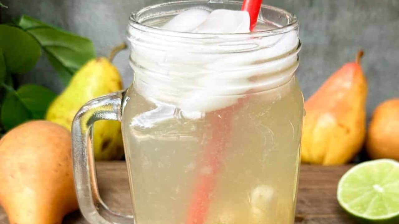 A warm and soothing ginger pear tea in a mason jar with a handle.