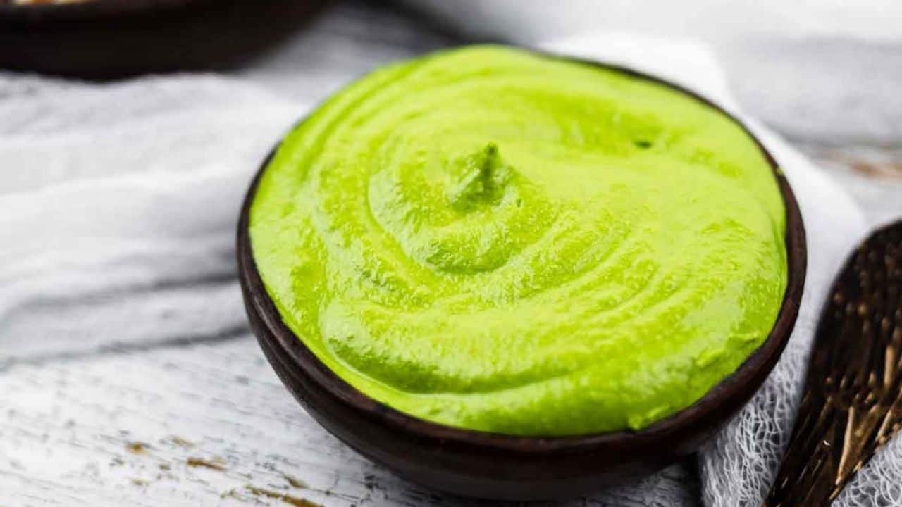 Green goddess vegan dressing blending in a blender.