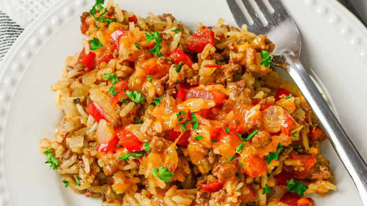 A skillet filled with beef, rice and vegetables.