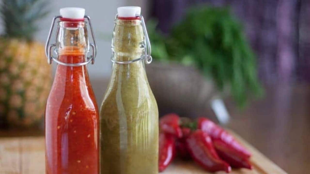 Bottled homemade hot sauce--one red and one green.
