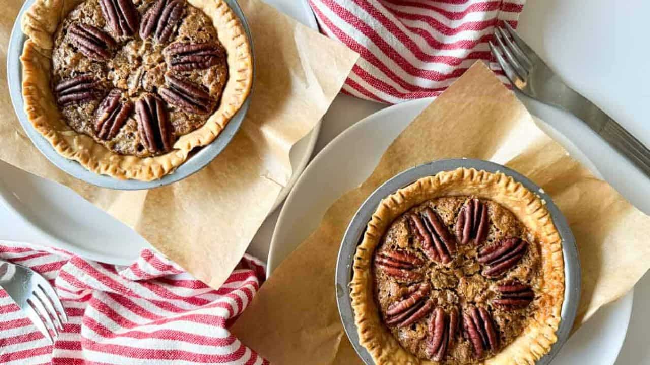 2 mini pecan pies on a table.