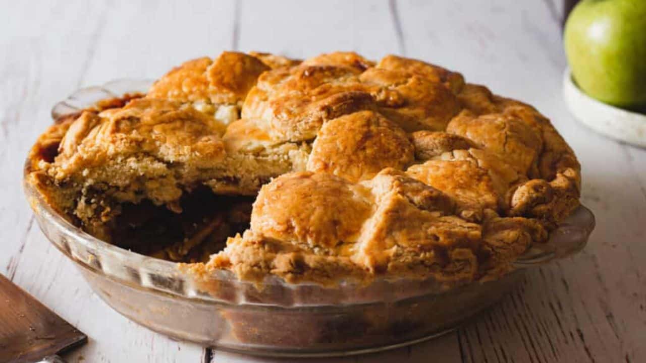 Overhead view of apple pie with apples.
