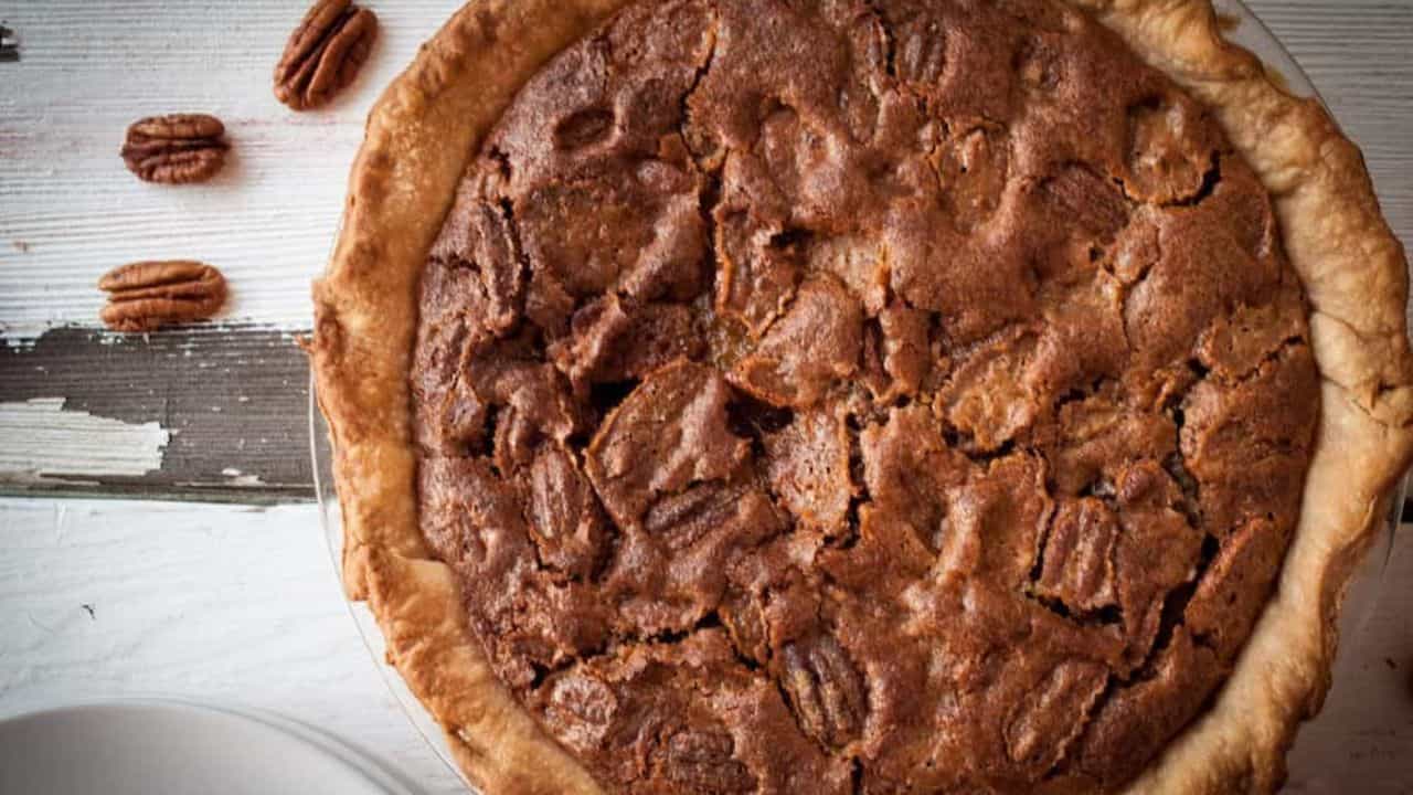 A bite pecan pie on a fork.