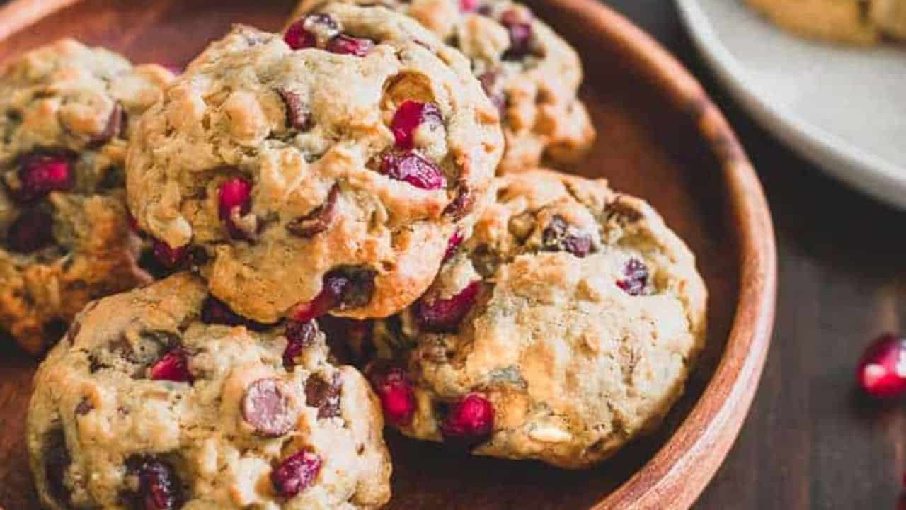 Pomegranate chocolate chip cookies on a wooden table.