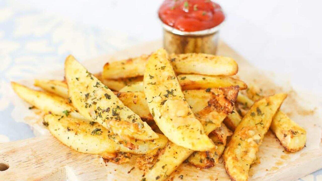 Overhead view of crispy potato oven fries with ketchup.