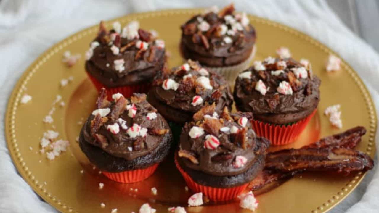 Gold plate with cupcakes, peppermint, and candied bacon pieces.
