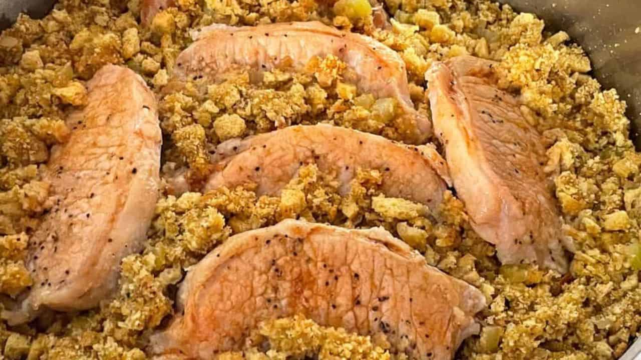 Stuffing and pork chops in a frying pan.