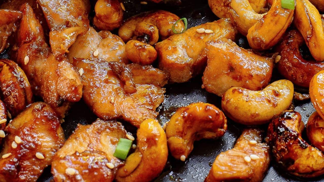 Sheet Pan Honey Soy Cashew Chicken with sesame seeds and chopsticks.