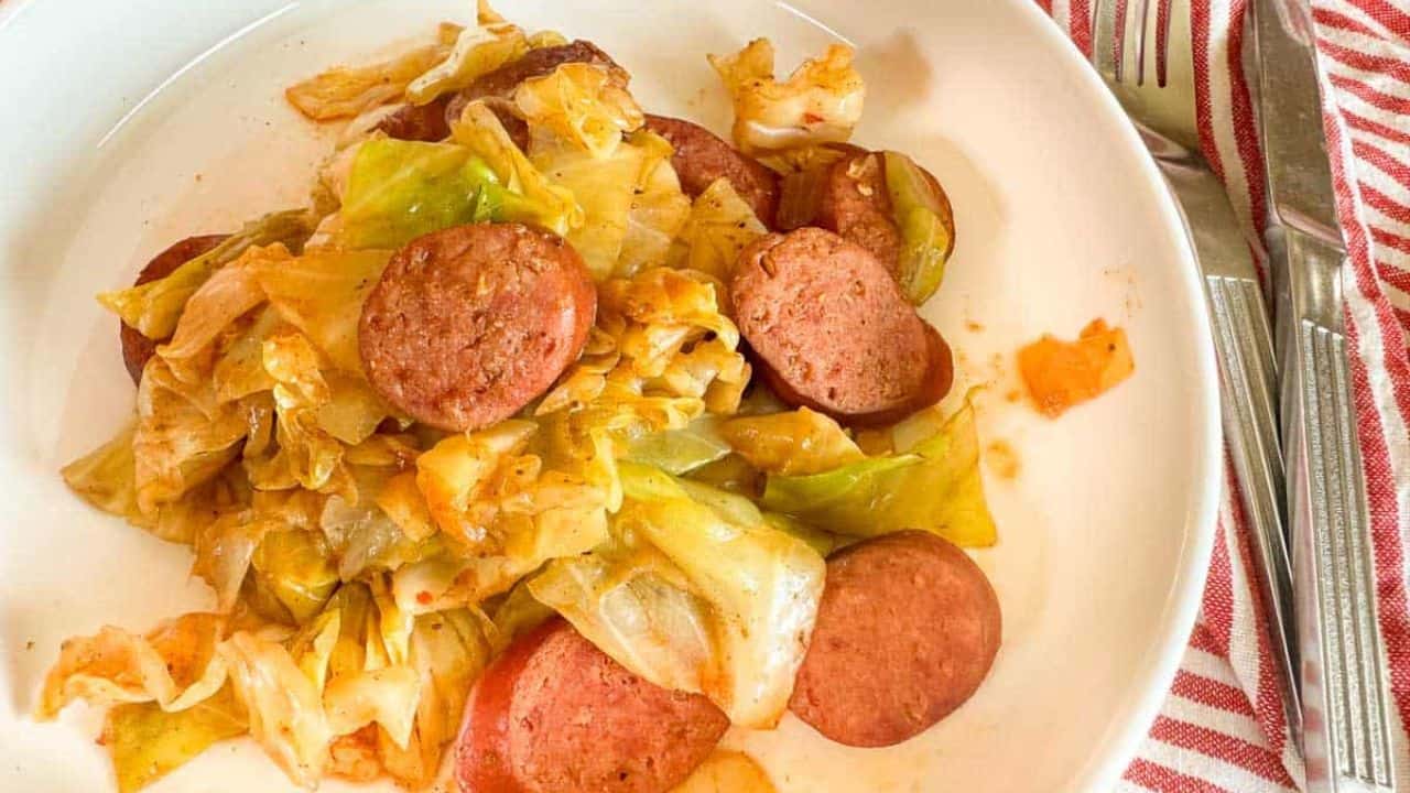 A bowl of cabbage and sausage.