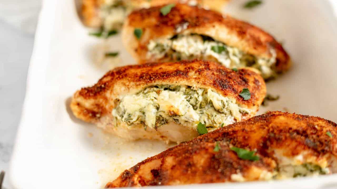 A baking dish full of stuffed chicken breasts.