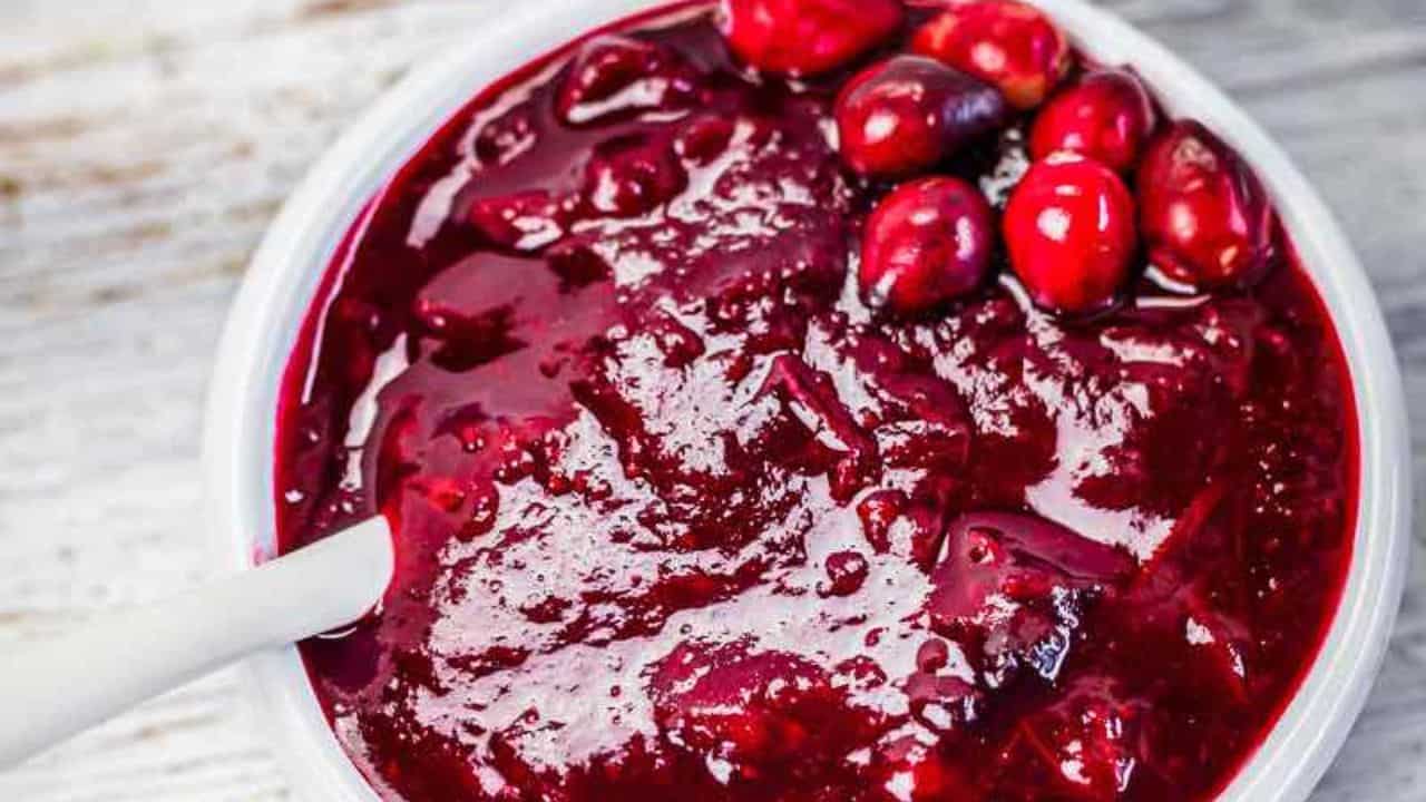Cranberry sauce in a glass container.