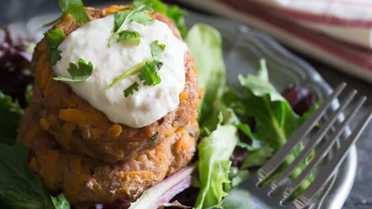 Sweet potato turkey patties stacked on baby greens.