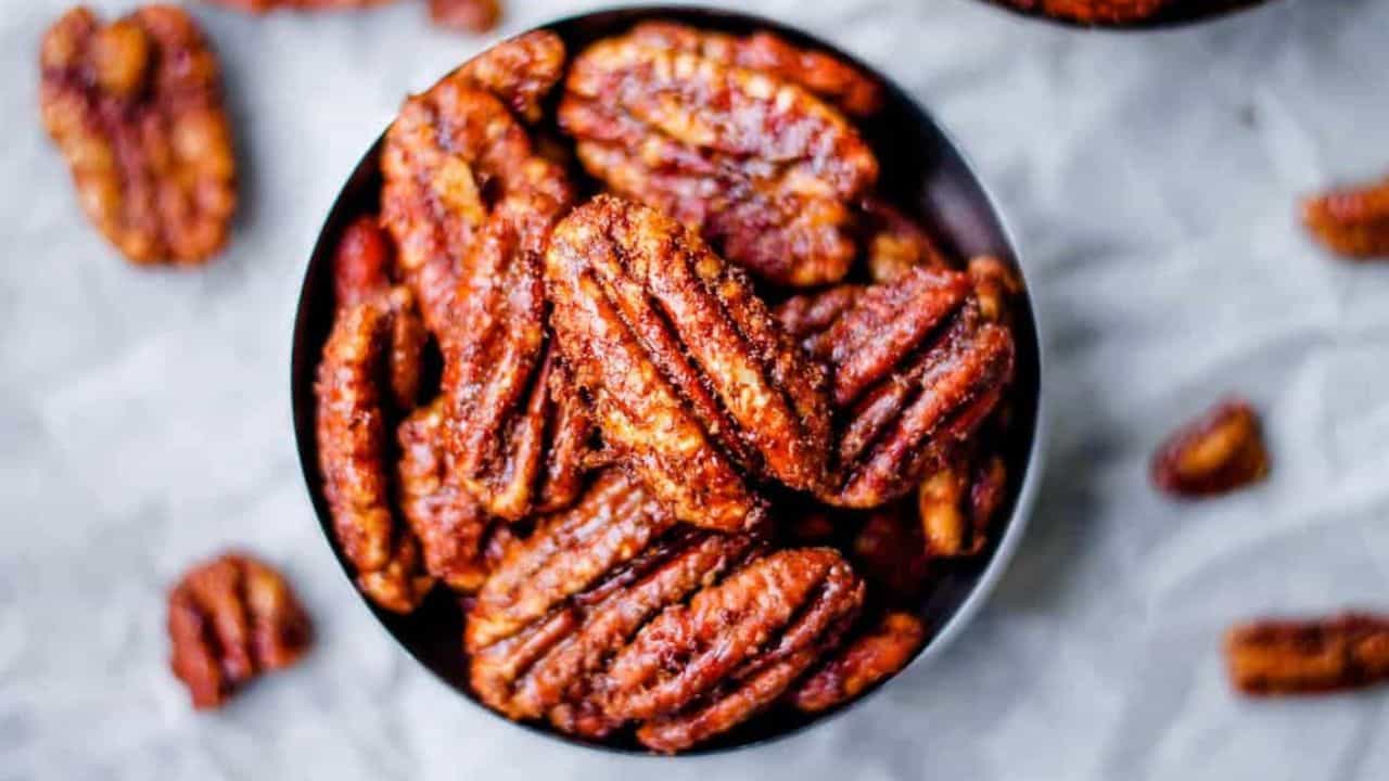 An overhead image of a small dish of texas glazed pecans.
