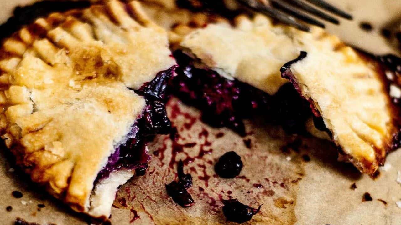 Closeup of a broken open triple berry hand pie.