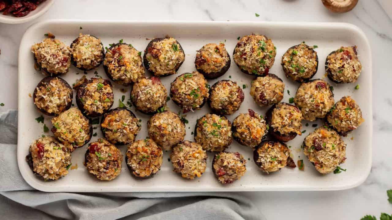 An overhead image of vegetarian stuffed mushrooms on a serving late.