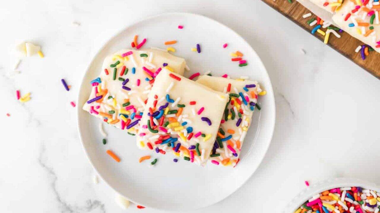An image of white chocolate fudge on a plate.