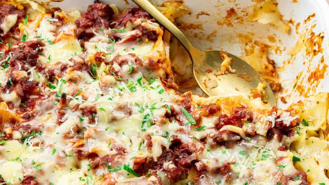 Noodles and ground beef are mixed with a cheesy topping together in a creamy casserole.