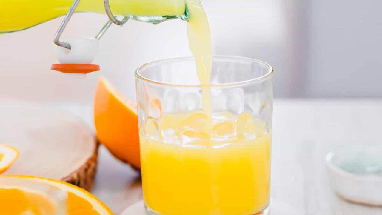 Pouring adrenal cocktail into a small glass.