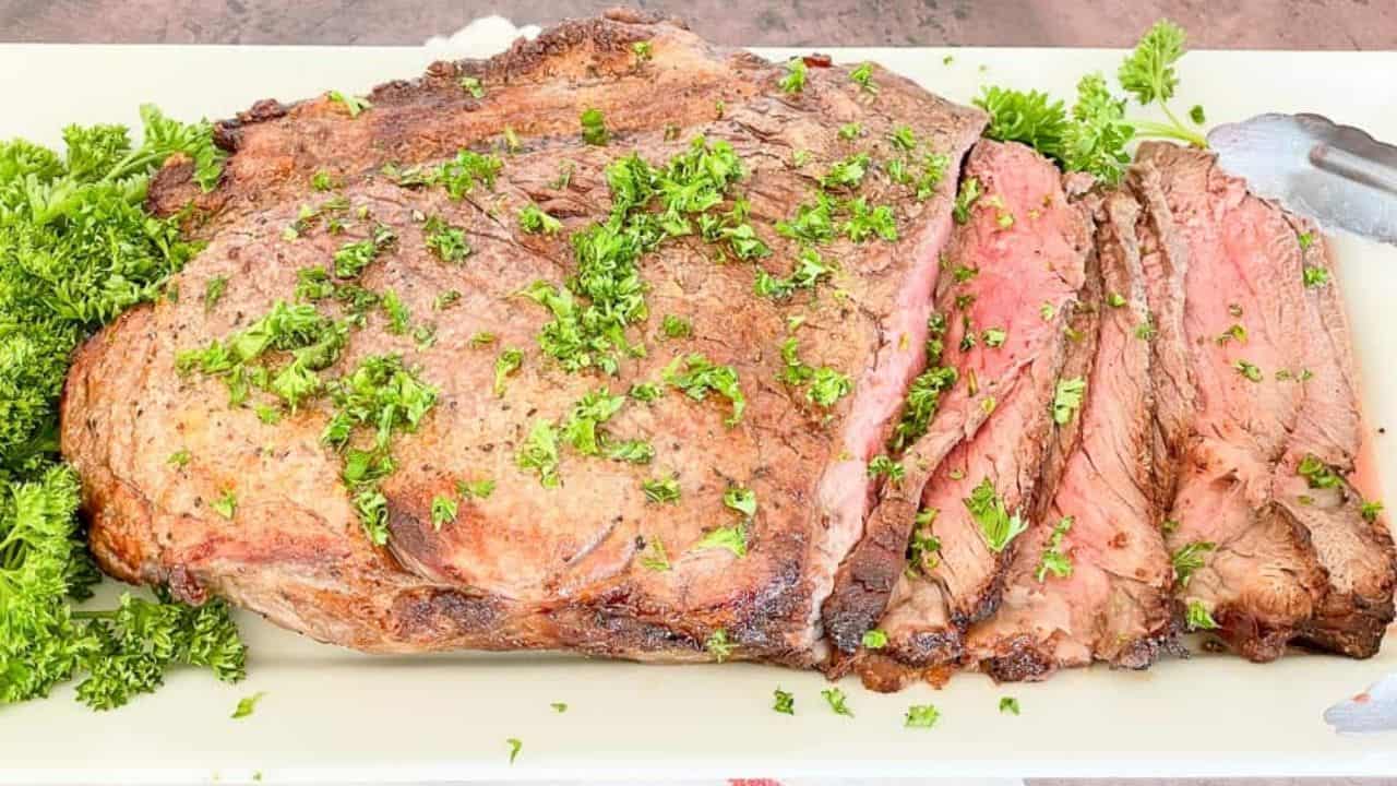 Sliced beef on a white platter.