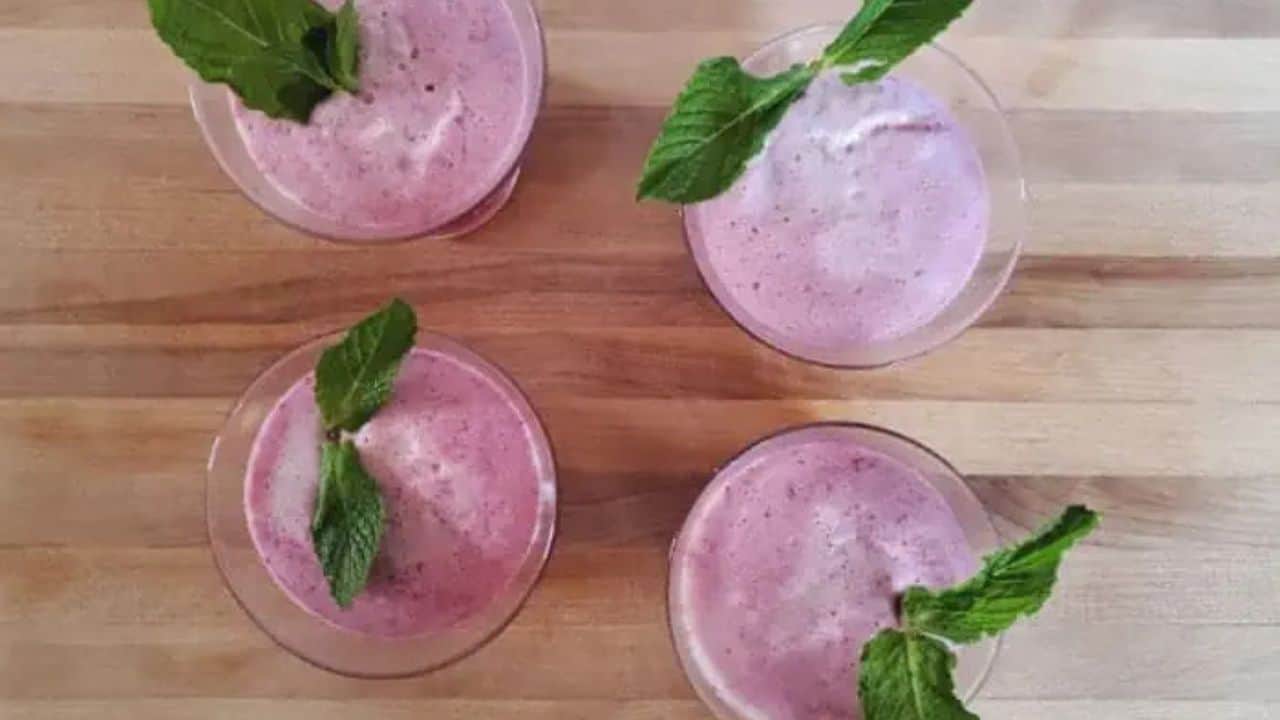 Image shows martini glassses with Cherry Fizz Cocktail and a mint garnish on each one.
