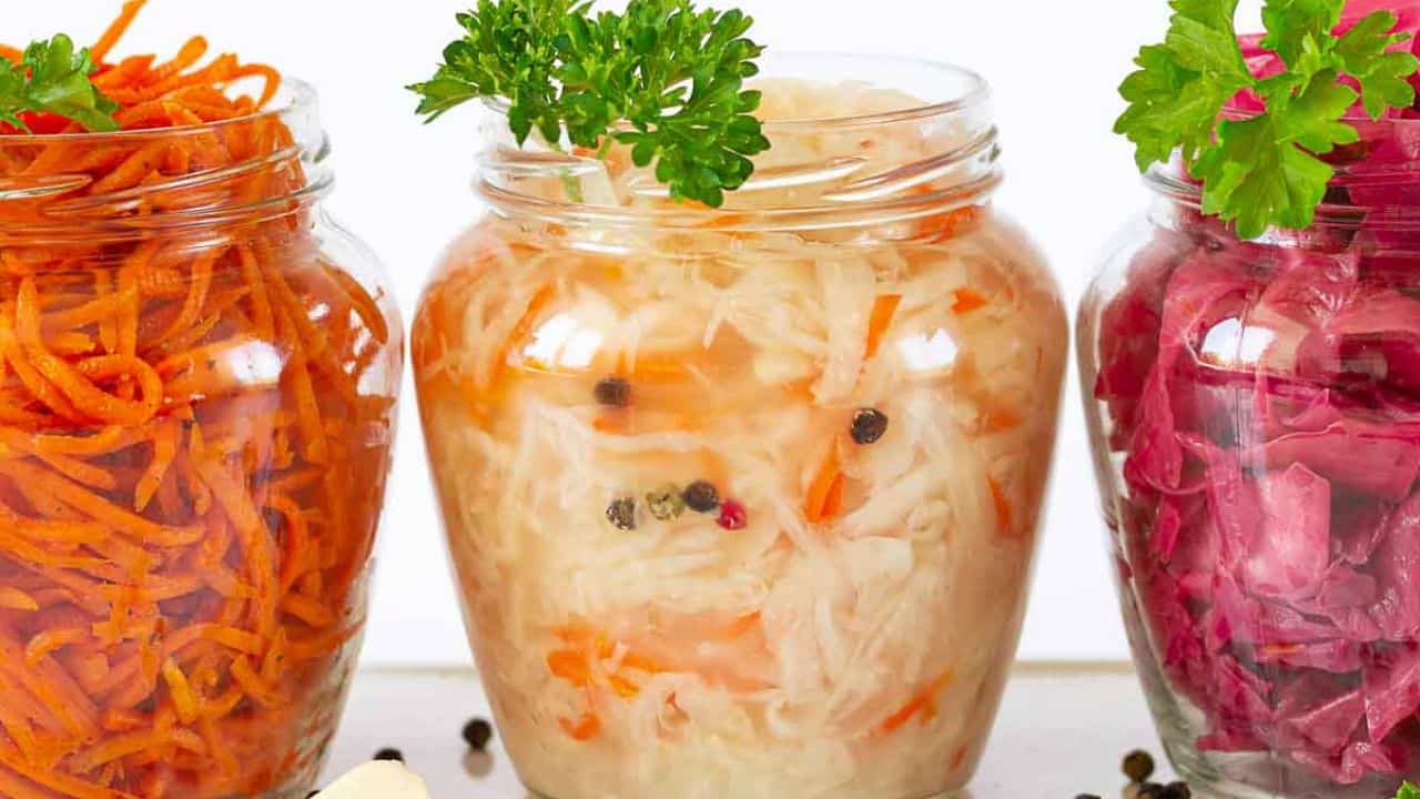 3 jars with fermented vegetables. Photo credit: Depositphotos.
