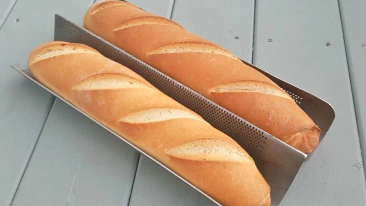 Image shows a closeup of two Baguettes in their pan from an overhead view.